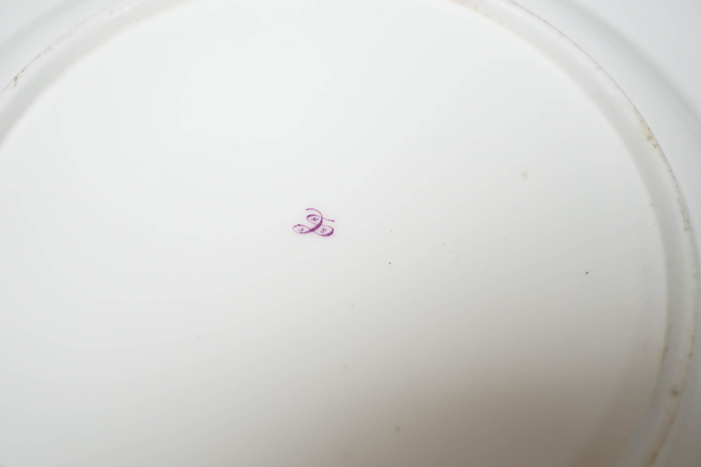 A Coalport plate painted with pink ground border, having alternating bird and flower panels and the centre with fruit and flowers, probably by Randall and Cook